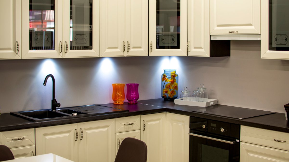 Modern kitchen with classic white cabinets and colorful decor, offering a timeless look.