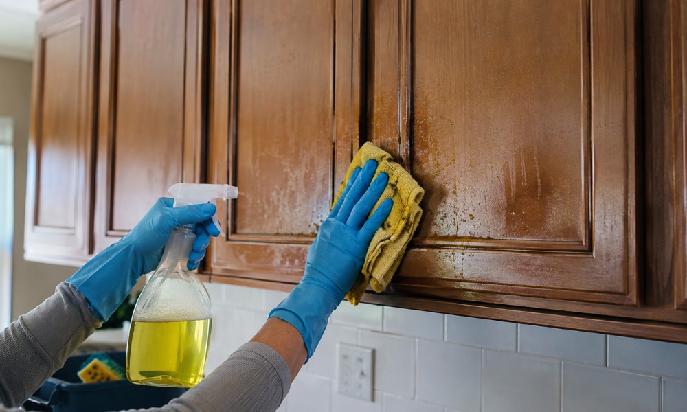 thoroughly cleaning a wooden kitchen cabinet door