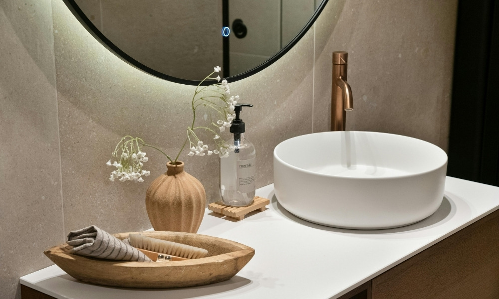 round vessel sink resting on a smooth white countertop